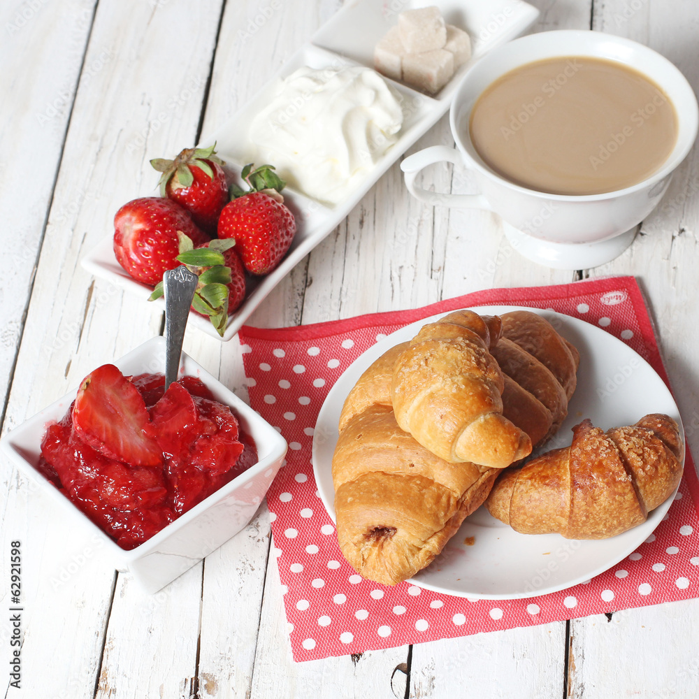 breakfast with croissants, strawberry and cup of coffe on white breakfast with croissants, strawberry and cup of coffe on white