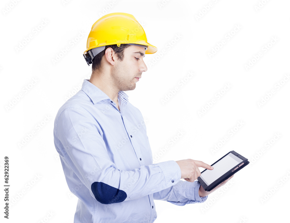 Handsome engineer working with a tablet pc, isolated on white Handsome engineer working with a tablet pc, isolated on white