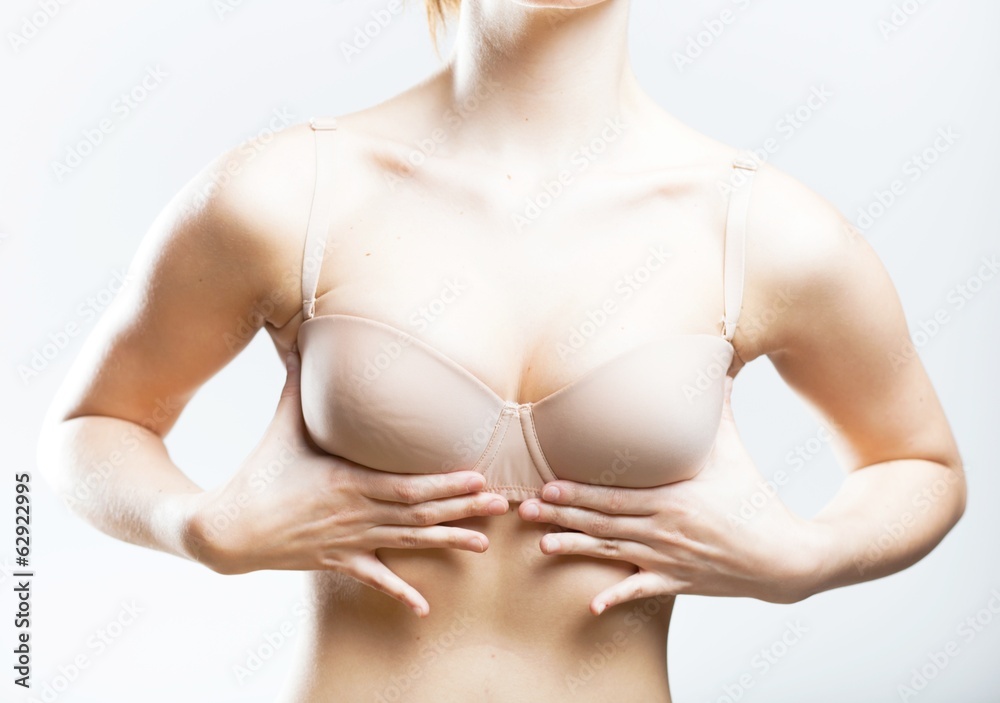Obraz premium Women holding her hands on breast pushing them up
