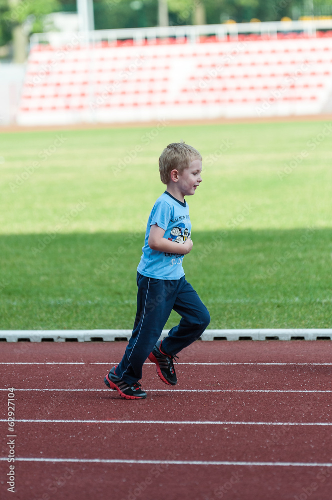 Fototapeta premium boy exercising on a treadmill