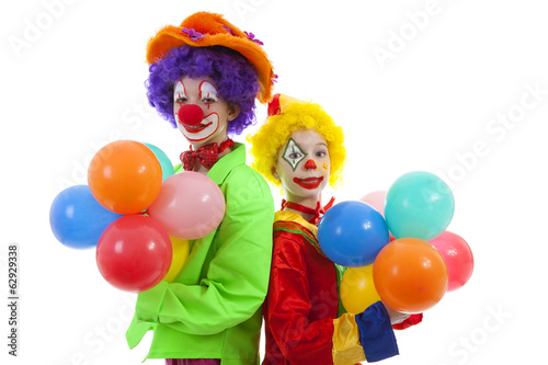children dressed as colorful funny clowns with balloons