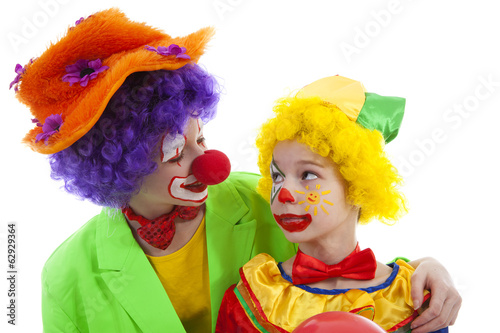 children dressed as colorful funny clowns
