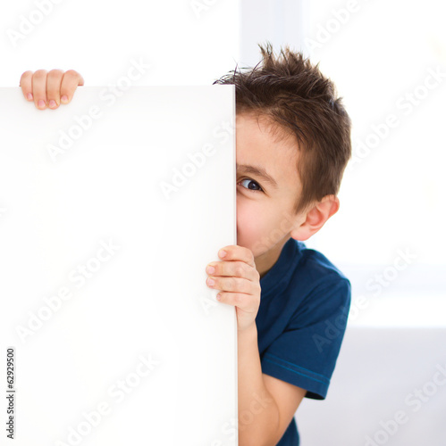 Cute boy is holding blank banner