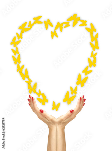 Paper yellow butterflies fly from woman hands over white backgro