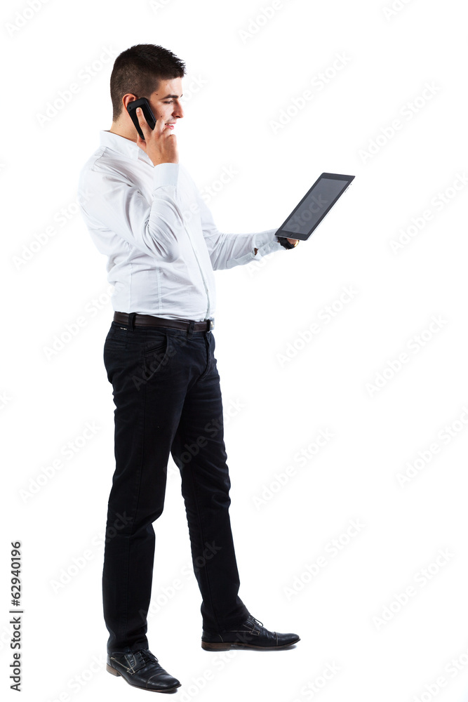 Young businessman with phone and tablet