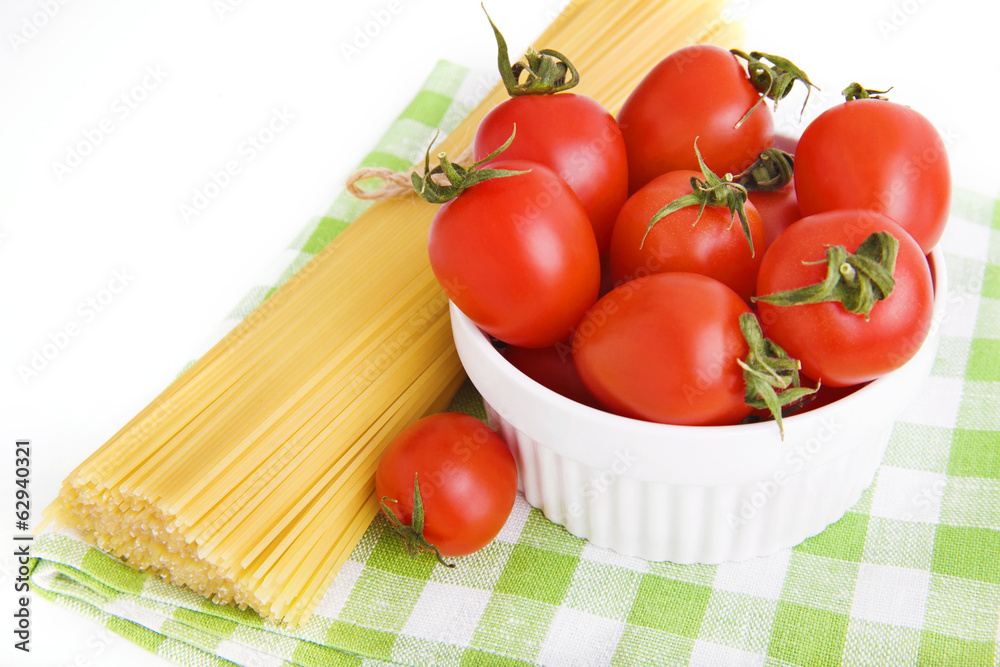 ingredients: сherry tomatoes in a bowl and spaghetti on green ingredients: сherry tomatoes in a bowl and spaghetti on green