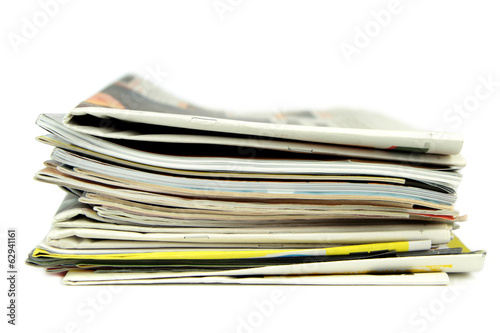 Pile of newspapers and magazines isolated on white background