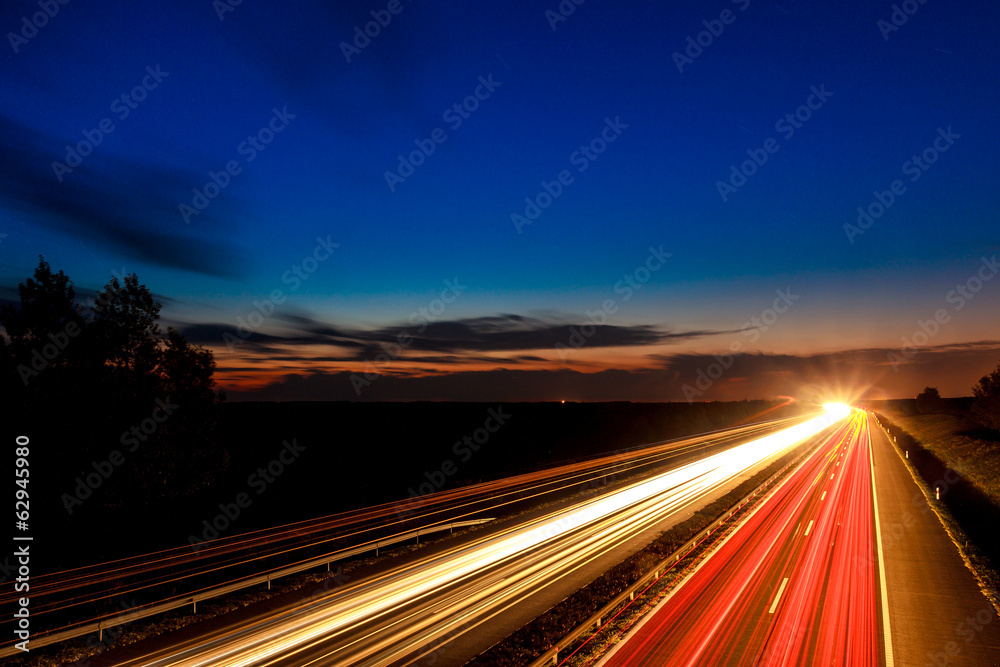 Cars speeding on a highway - obrazy, fototapety, plakaty 