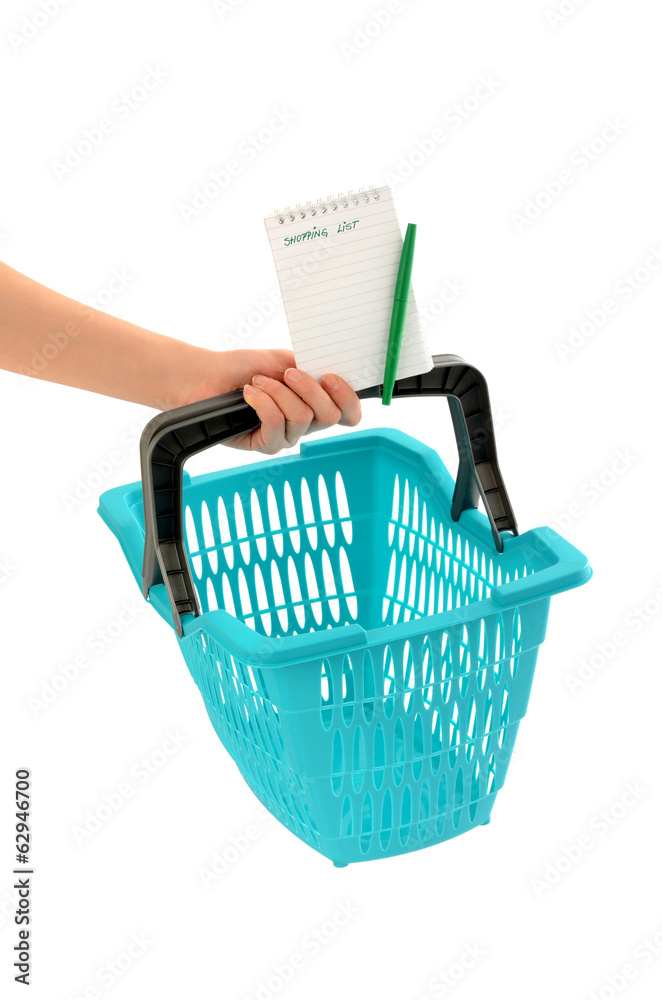 Fototapeta premium Woman hand holding a market basket with blank shopping list.