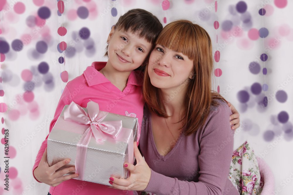 Loving mother and daughter with present Loving mother and daughter with present
