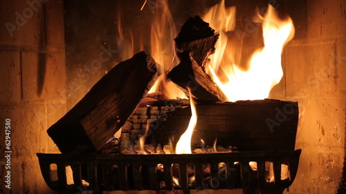 Burning wood in stone fireplace