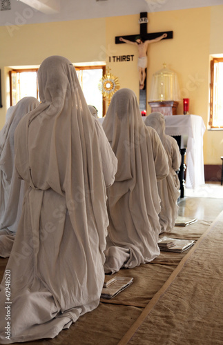 Missionaries of Charity in prayer in Mother House, Kolkata photo