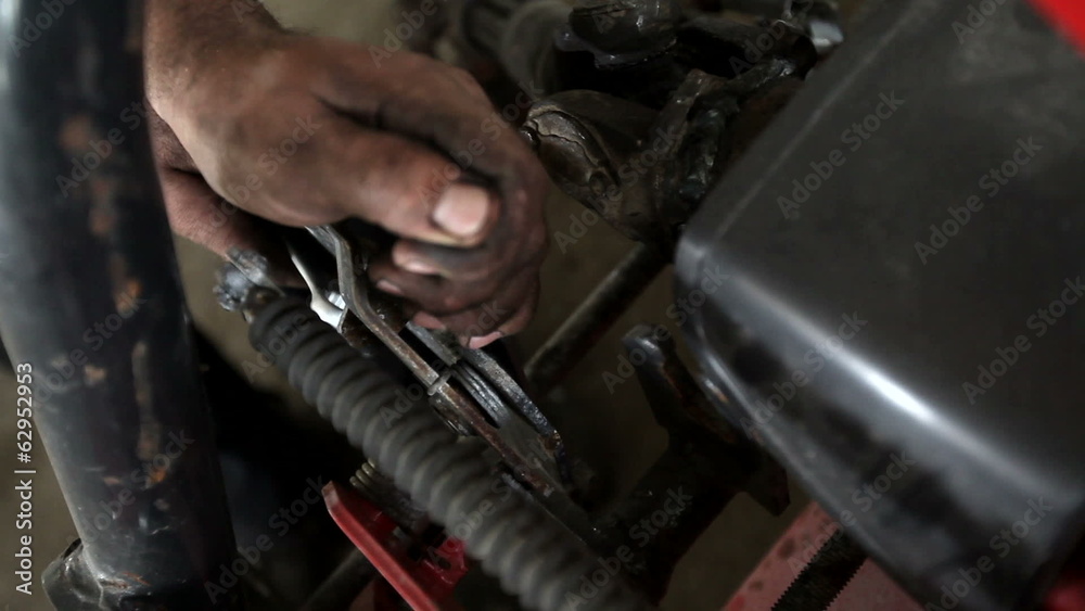 Closeup of mechanic with dirty hands fixing with wrench Closeup of mechanic with dirty hands fixing with wrench