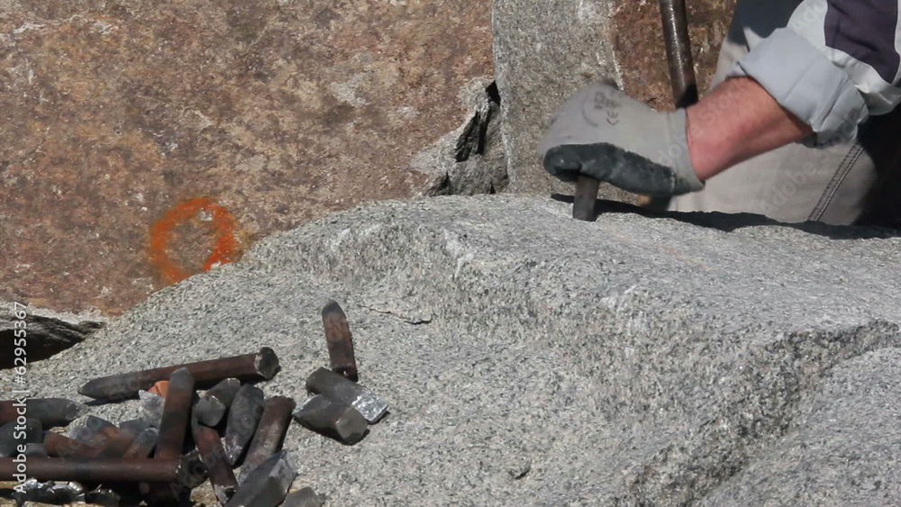 Stonemason making wedge-holes manually