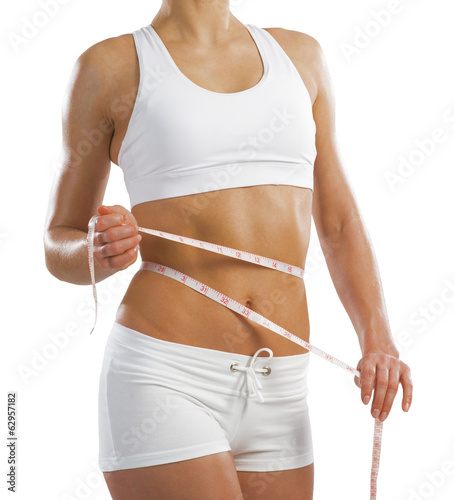 young athletic woman measuring waist