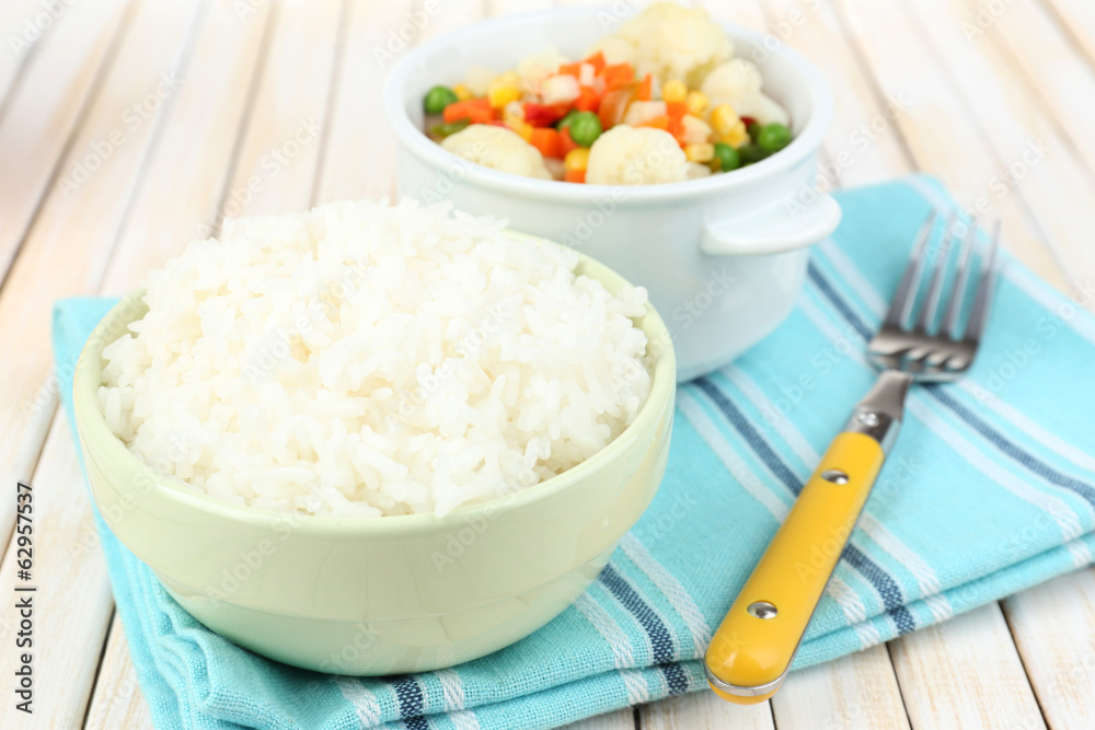 Cooked rice with vegetables on wooden table close up Cooked rice with vegetables on wooden table close up