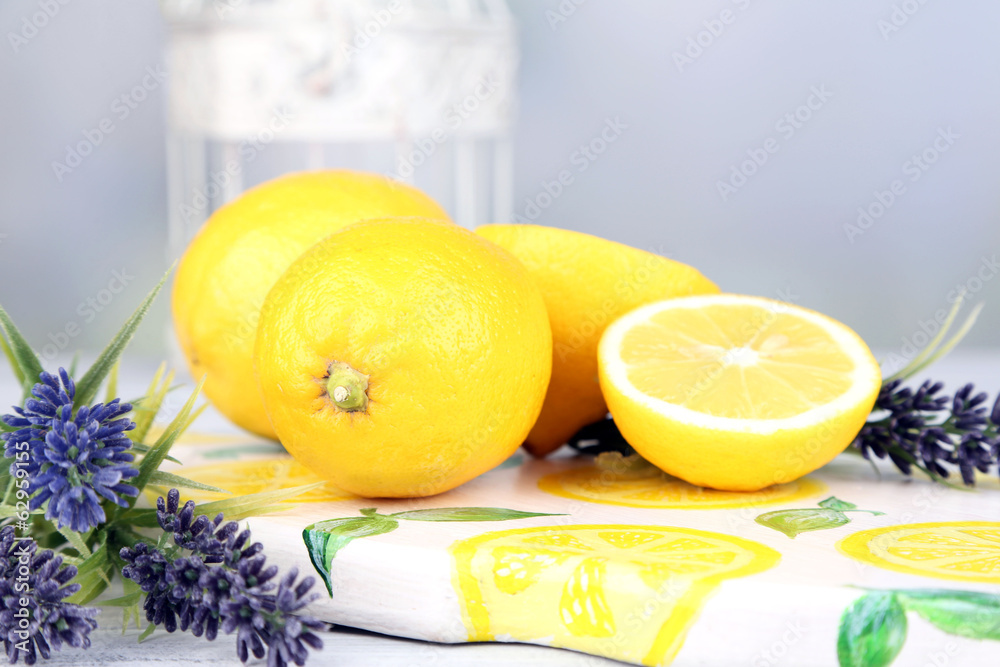 Still life with fresh lemons and lavender on light background Still life with fresh lemons and lavender on light background