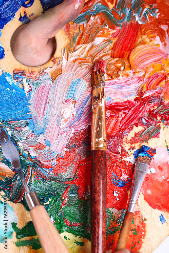 Paints, brush and art palette close-up