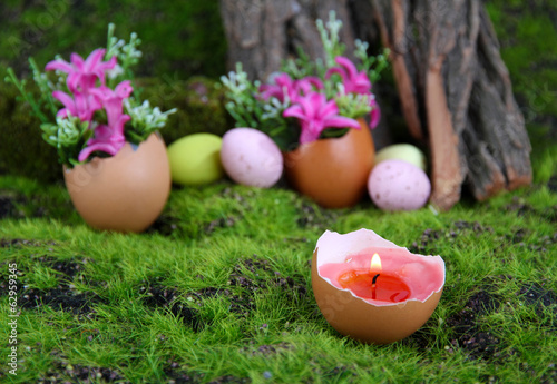 Conceptual Easter composition. Burning candle in egg and