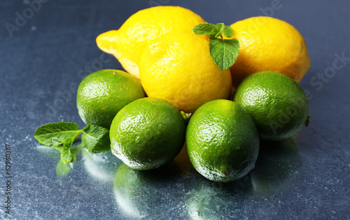 Lemons and limes on dark background
