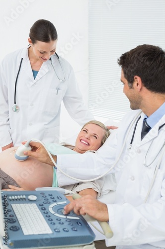 Excited pregnant woman having a sonogram scan