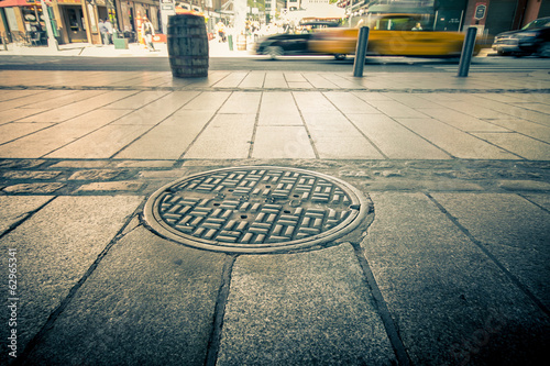 Manhole drain cover on streets of lower Manhattan photo