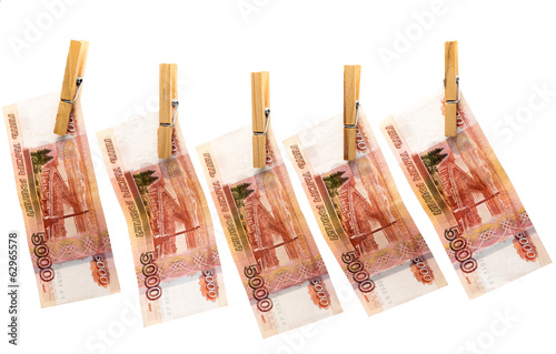 Five thousand roubles on clothespins on white background
