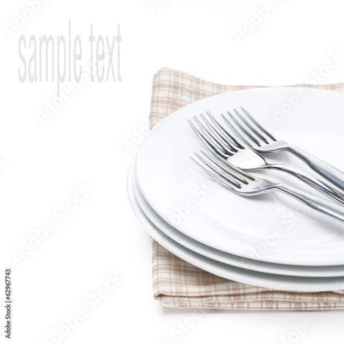 plates and forks - utensils for serving on napkin, isolated