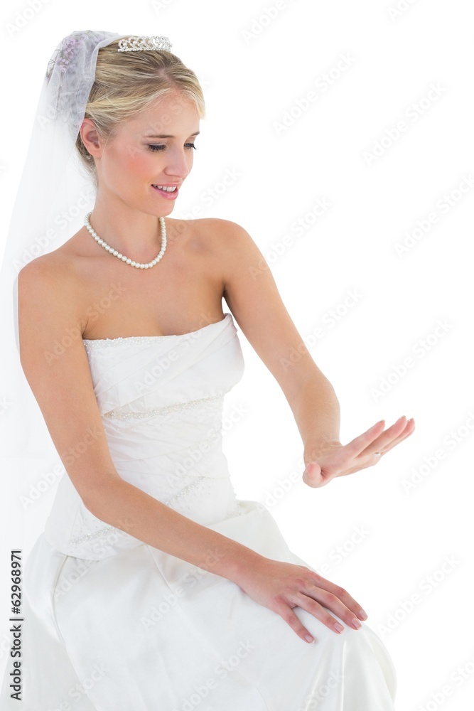 Bride looking at wedding ring over white background Bride looking at wedding ring over white background