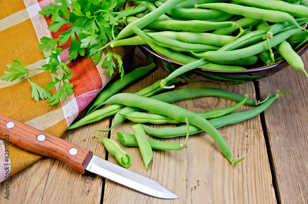 Beans green on board with knife and napkin