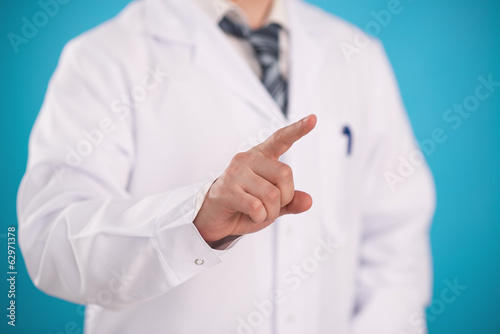 Close-up of doctor's finger pushing virtual button on monitor