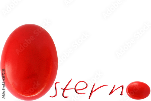 Rotes Osterei neben Schrift