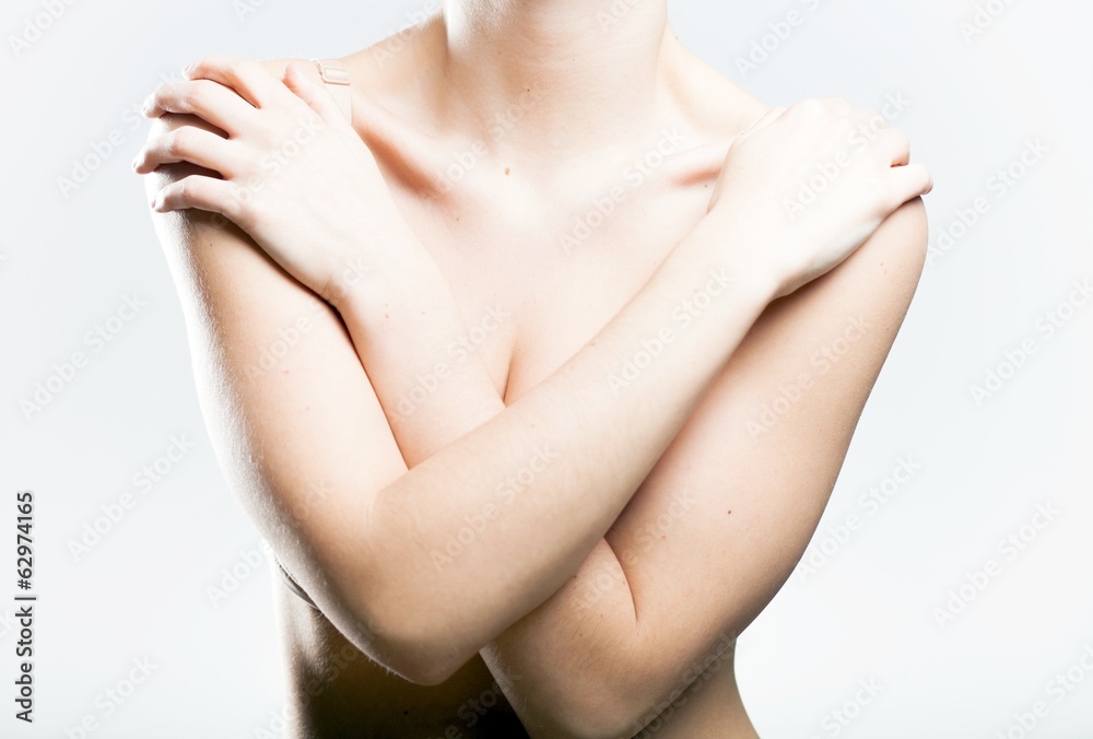 Fototapeta premium Woman covering her breasts arms