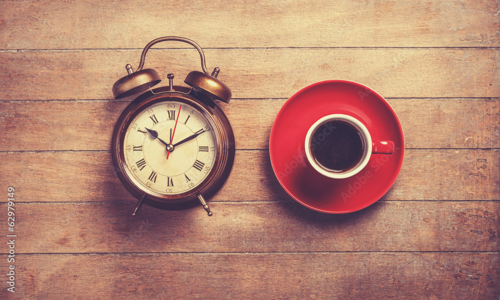Alarm clock and cup of a coffee Alarm clock and cup of a coffee