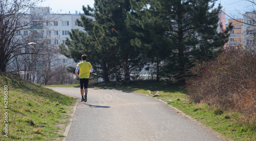 Man running in city park