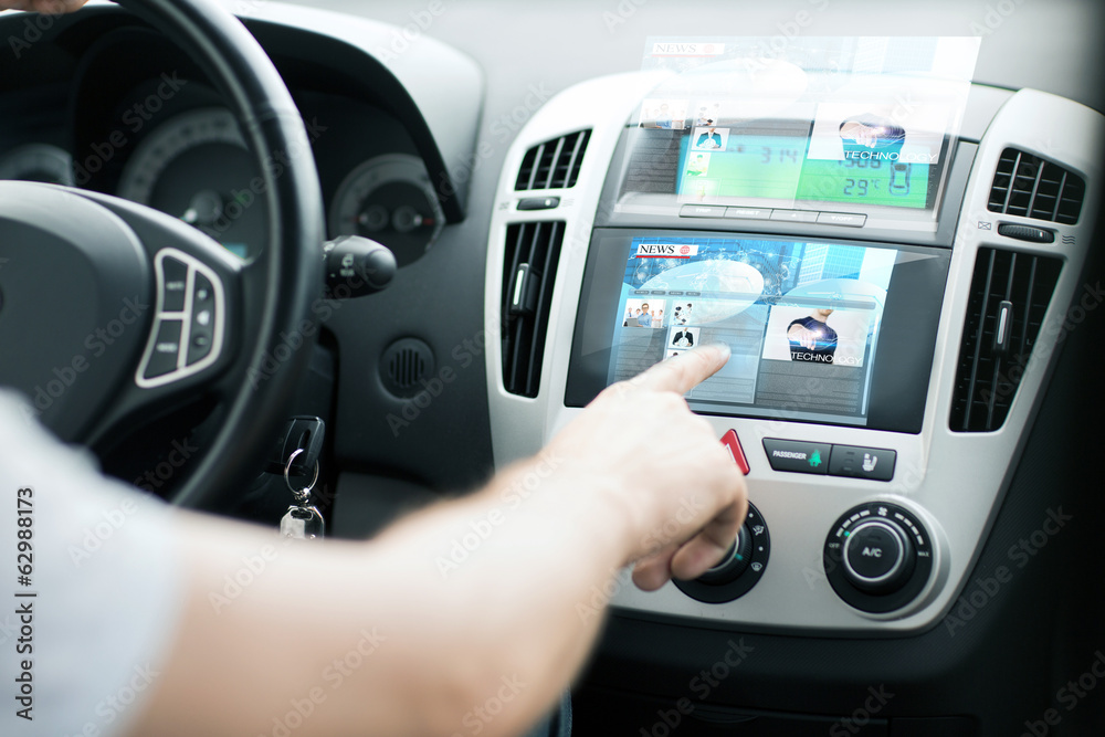 man using car control panel to read news man using car control panel to read news