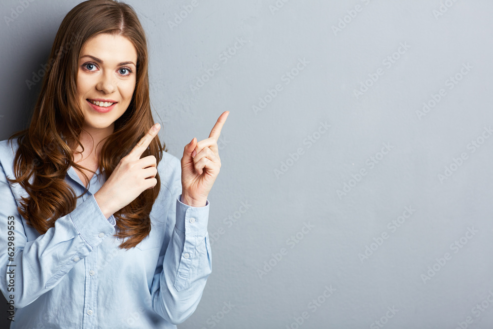 Smiling business woman finger pointing at the side. Smiling business woman finger pointing at the side.