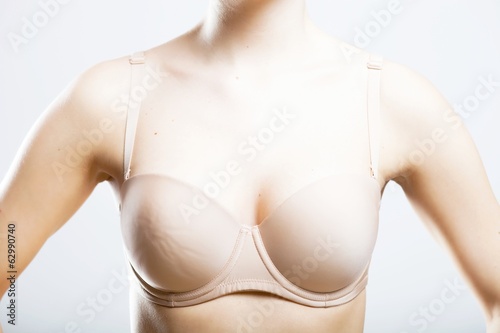 Skin-colored bra, breast of young woman
