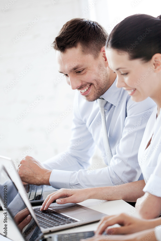 man and woman working with laptop in office man and woman working with laptop in office