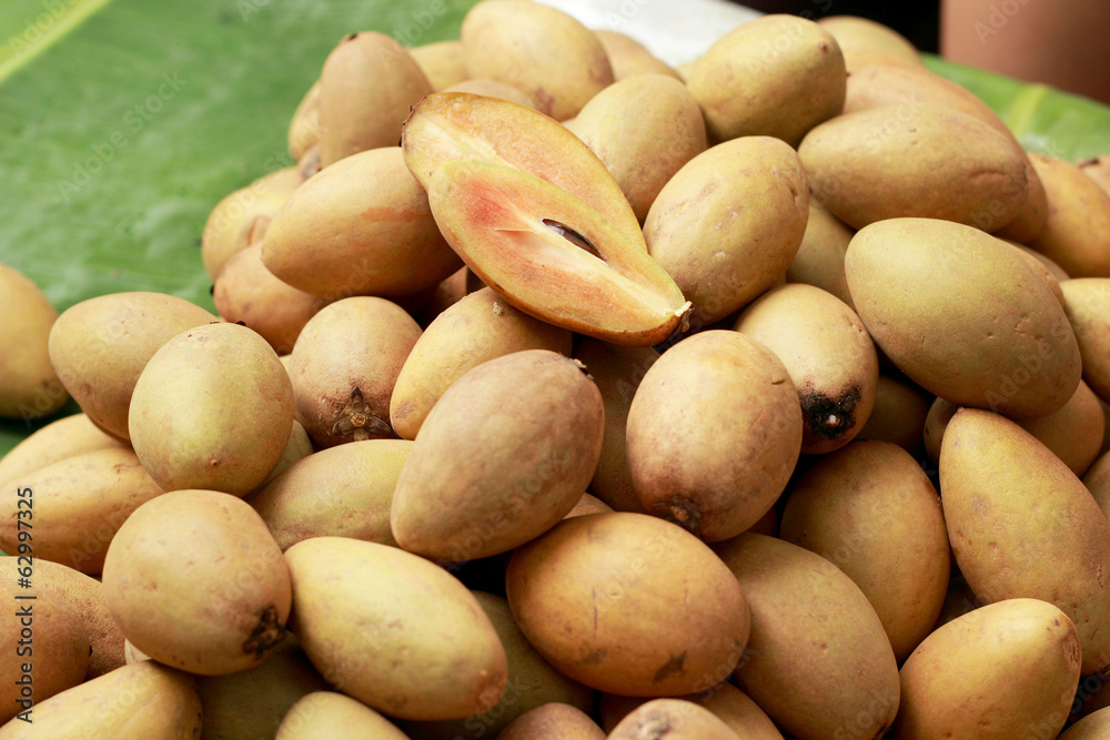 Sapodilla fruit pile in the background Sapodilla fruit pile in the background