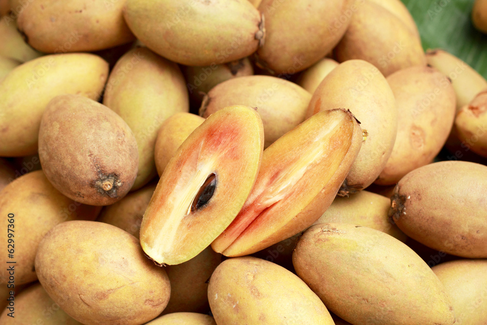 Sapodilla fruit pile in the background Sapodilla fruit pile in the background