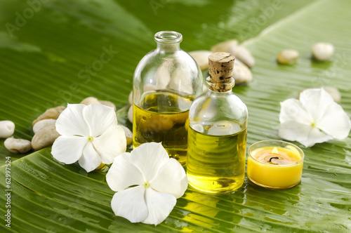 Health spa with massage oil and white flower