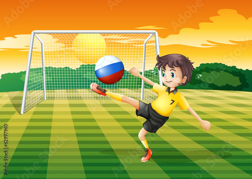 A girl kicking the ball with the Russian flag