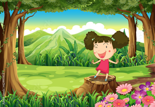 A cute little girl above the stump at the forest