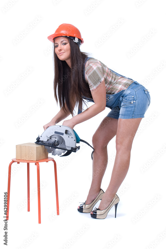Young woman holding an electric circular disk saw. Young woman holding an electric circular disk saw.