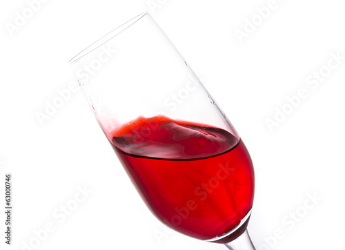 isolated of red water in wine glass is motion on white backgroun