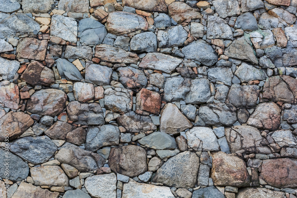 wall composed of variety size of rocks wall composed of variety size of rocks