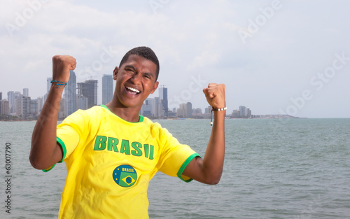 Happy brazilian guy at beach photo