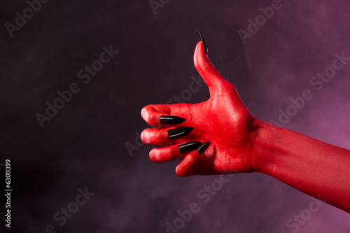 Red devil hand showing thumbs up