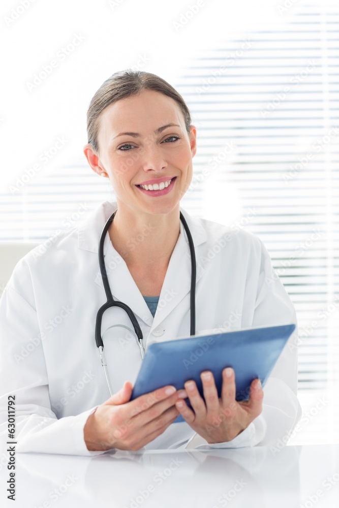 Confident female doctor holding digital tablet Confident female doctor holding digital tablet